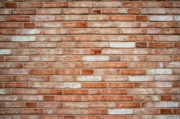 Vintage red brick wall that has changed color over time. Textured background. Copy space.