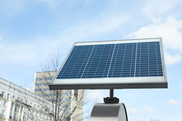 Small solar panel on city street. Alternative energy - obrazy, fototapety, plakaty
