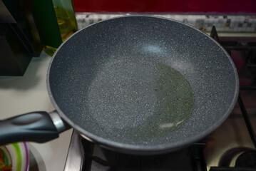 Frying pan with cooking oil on stove