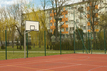 Basketball court at outdoor sports complex on sunny day