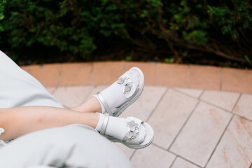 unrecognised girl's legs in white socks 
