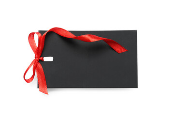 Blank black gift tag with red satin ribbon on white background, top view. Space for design