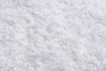 Soft white knitted fabric as background, closeup