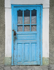 Old blue wooden door on village house