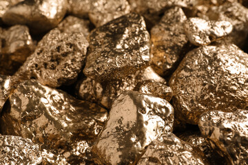 Pile of gold nuggets as background, closeup