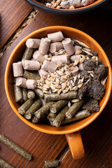 sunflower cake flakes with grass and bran granules and cereals for horses and other domestic animals. food concept. flat lay