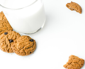 Chocolate chip cookies with glass of milk on wood plate and isolated white background. 