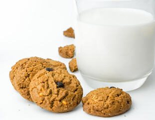Chocolate chip cookies with glass of milk on wood plate and isolated white background. 
