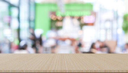 abstract blur modern interior of cafe restaurant with circle bokeh light and modern wood table perspective to show ads, and promote content or product on background