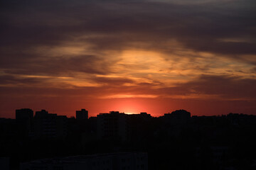 Dramatic sunset sky with clouds over the city