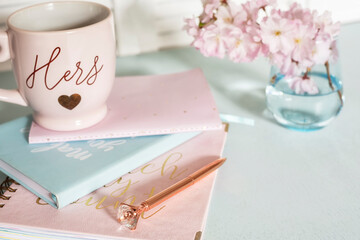 notebooks for notes and delicate spring flowers. lovely soft colors. Selective focus.
