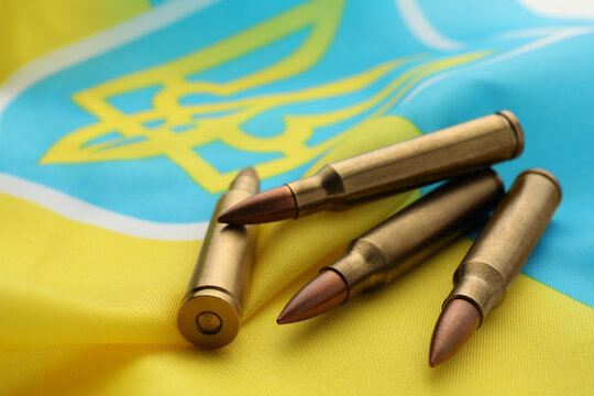 Bullets on national flag of Ukraine, closeup