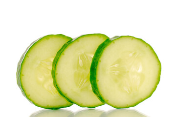 Three slices of juicy smooth cucumber, macro, isolated on a white background.