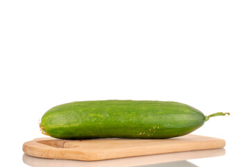One juicy smooth cucumber on a wooden cutting board, macro isolated on a white background.