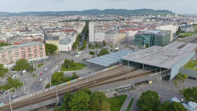 flight over vienna city sunny day traffic street train station district aerial panorama 4k austria
