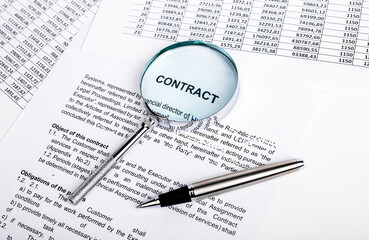 Fototapeta premium Contract with magnifier and pen. Careful assessment of treaty terms and conditions, legal aspects before signing. Audit conducting. High quality photo