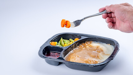 Turkey and gravy TV dinner with forked vegetables