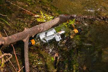 Two glass bottles were simply thrown away into a stream in the environment by careless people