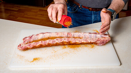 BBQ rub is applied to the back side of ribs