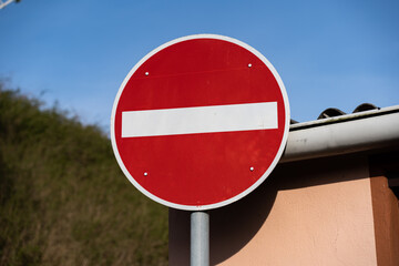 No entry road sign in Germany. Close-up of a traffic sign. Red round shape with a horizontal white...