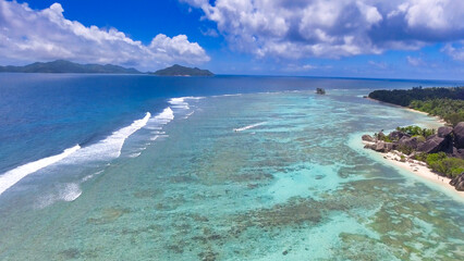 Obraz premium Coral Reef from drone. Seychelles beach and rocks on a sunny day