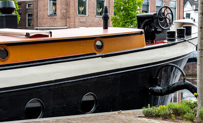 Black-orange barge bow on the canal