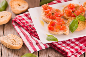 Friselle with cherry tomatoes and basil.
