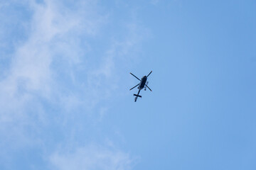 Flying police helicopter with blue sky