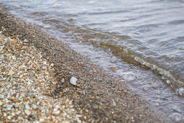small pebbles on the bank of the Volga river on a clear day