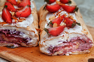 Ready-made, tasty meringue roll in cut. Close up