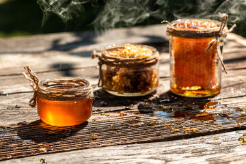 Natural honey comb and a glass jar on wooden table. Honey background. Sweet honey