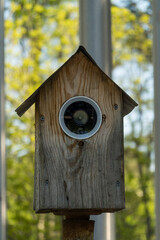 A birdhouse disguised as a video surveillance camera.
