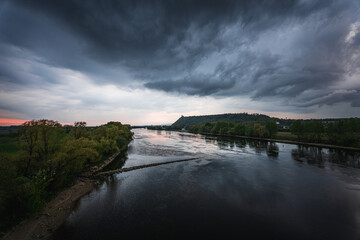 Fototapeta na wymiar Dark storm clouds in the evening sky at the Danube in Bavaria, Germany