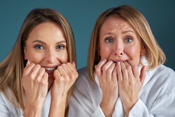 Two girls wearing bathrobe in spa or hotel having fun