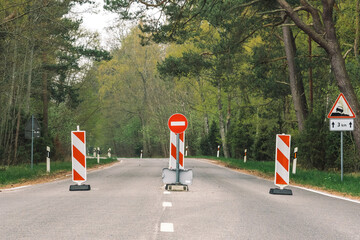Travel restrictions, road closed, borders closure, borders closed, empty road and forest with stop...