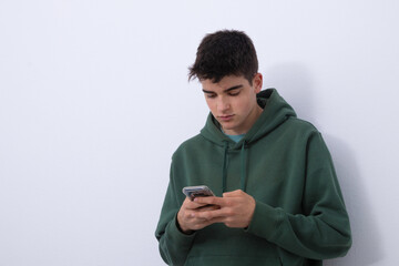 isolated teen boy looking at mobile phone