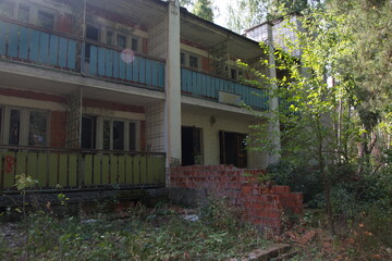 destroyed brick buildings on the territory of an old children's camp in the summer forest. Ulyanovsk