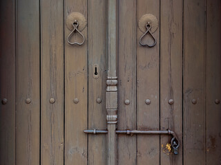 Wooden door with iron locking gear close-up
