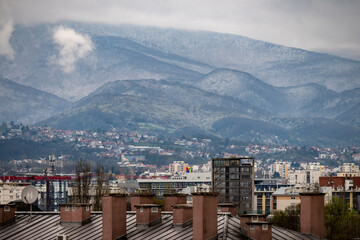 Snow covered slopes of Medvednica mountain in the morning with Zagreb city buildings in the foreground