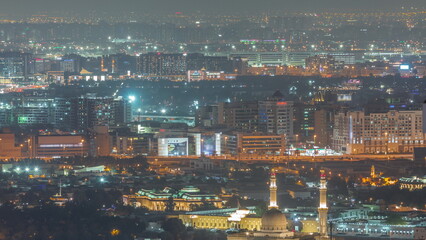 Aerial view of Bur Dubai, the Creek, Deira district and Sharjah night timelapse