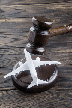 Judges gavel and toy airplane. Aviation law or flight restrictions concept