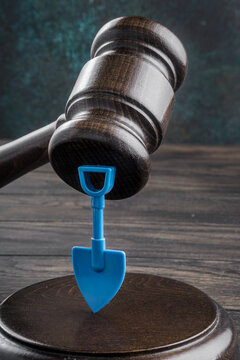 Gavel and toy plastic shovel. Employment protection legislation, labor protection law
