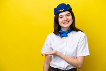 Airplane stewardess Russian woman isolated on yellow background presenting an idea while looking smiling towards