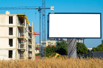 Blank white advertising billboard on the construction site area © diesirae