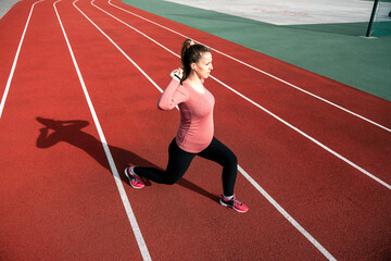 Prenatal gymnastics. Pregnant woman training yoga sport exercise. Prenatal healthy fitness active fit gym outside. Pregnancy fitness.