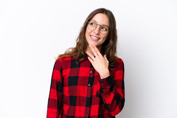 Young caucasian woman isolated on white background looking up while smiling