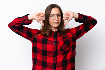 Young caucasian woman isolated on white background showing thumb down with two hands