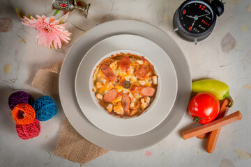Creamy roma pasta with tomato in a plate top view on wooden background