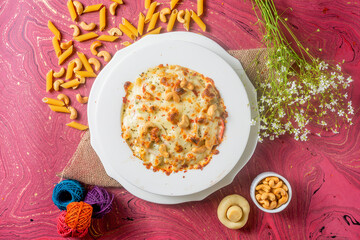 chicken cheese Cashew nuts pasta in a plate top view on wooden background