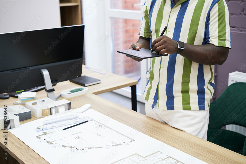 Aufkleber close-up of african designer using graphic tablet to draw blueprint of new construction project